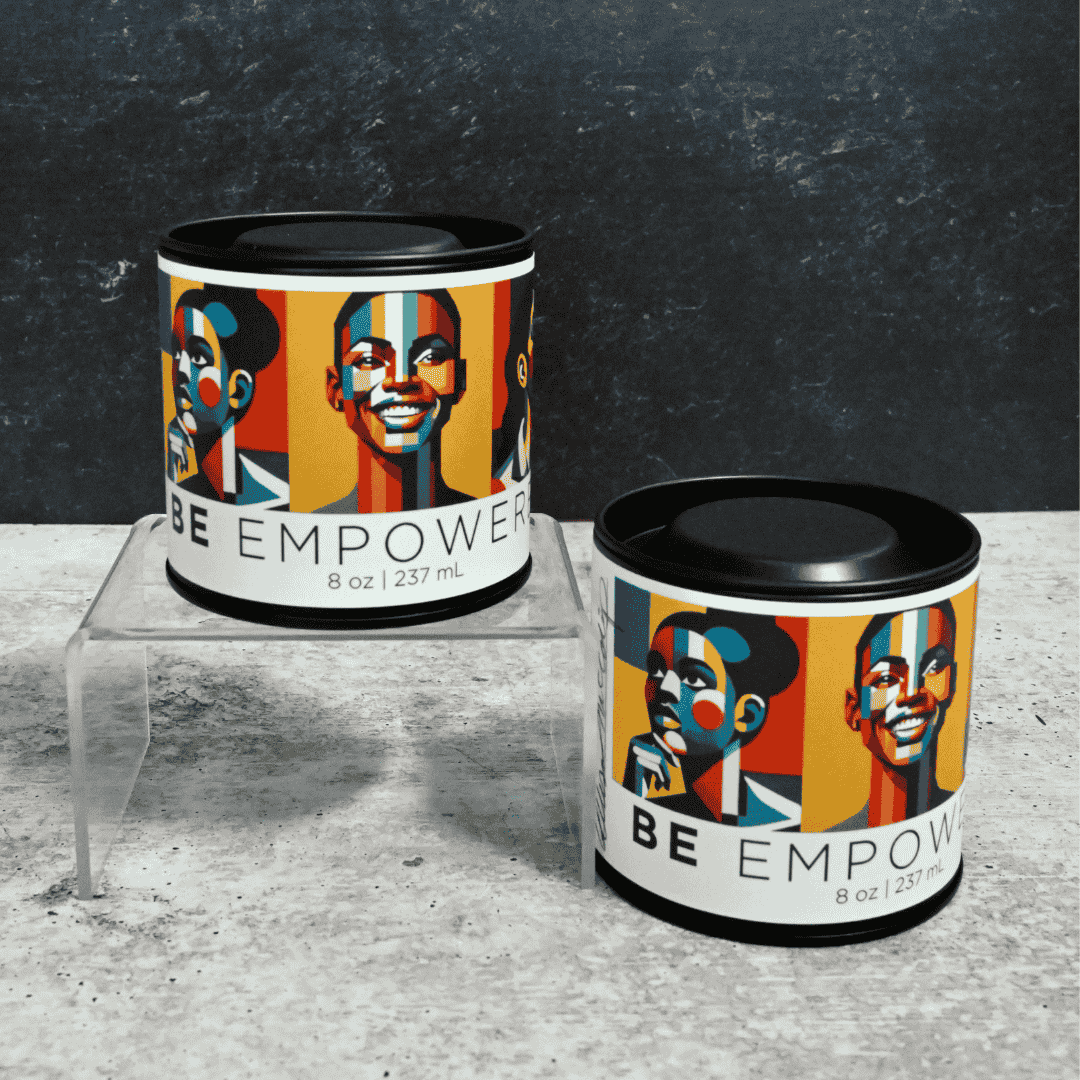 Two 'BE EMPOWER' candles on a gray surface with a dark textured background