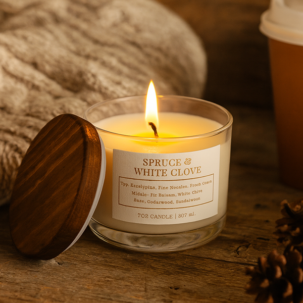 Holiday soy candle with pine cones and blanket