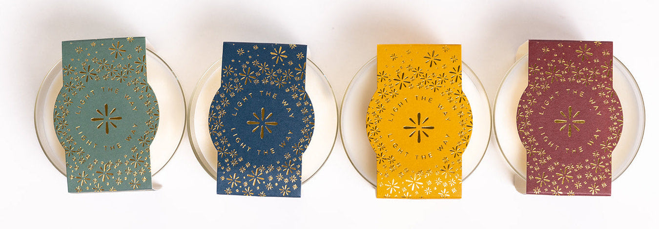 Row of soy candles with colorful labels