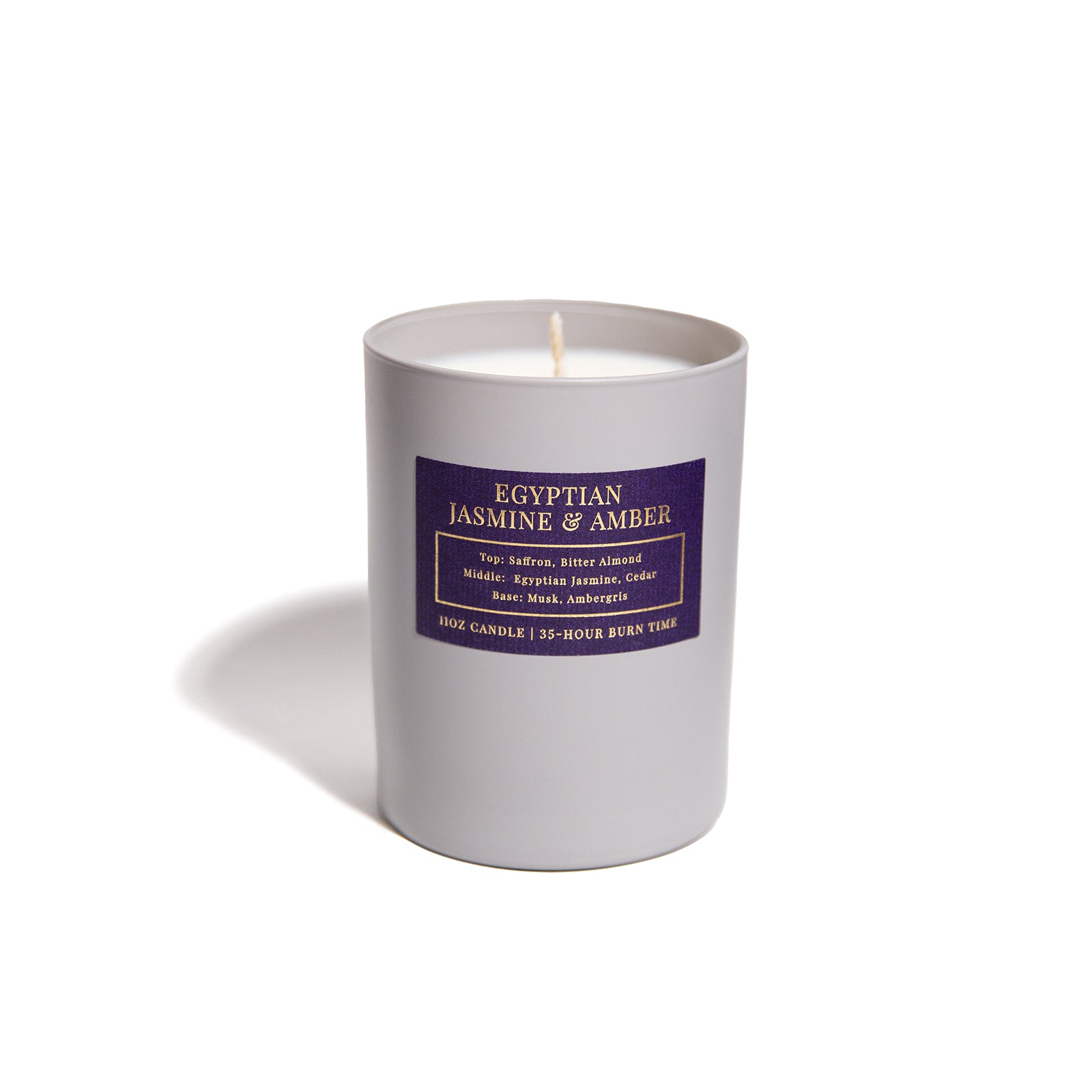 Egyptian Jasmine and Amber candle with purple label and grey vessel.