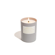 Spruce and white clove candle on white background in grey vessel. 
