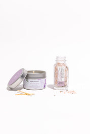 Candle, bath salts, and a bottle of essential oils on a white background